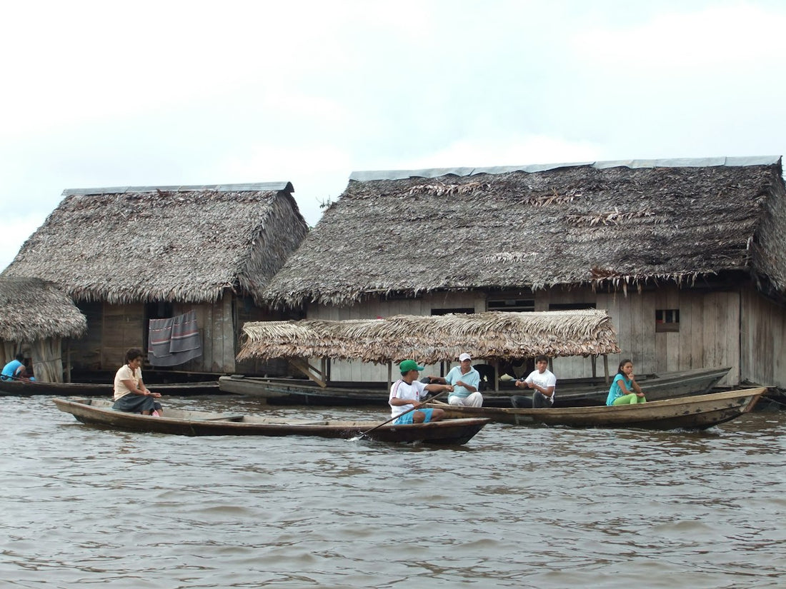 Wooden boats and thatched stilt houses on the river in Belén, Iquitos, in the Peruvian Amazon