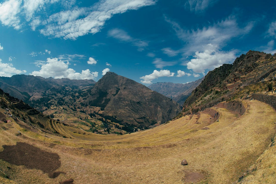 Terraced highland slopes and mountains in the Peruvian Andes under a blue sky